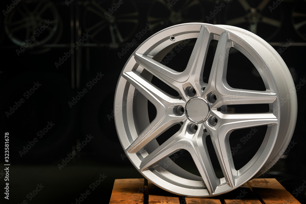 alloy wheel silver, rim new car wheel on a black background close up. Copyspace copy space, front view