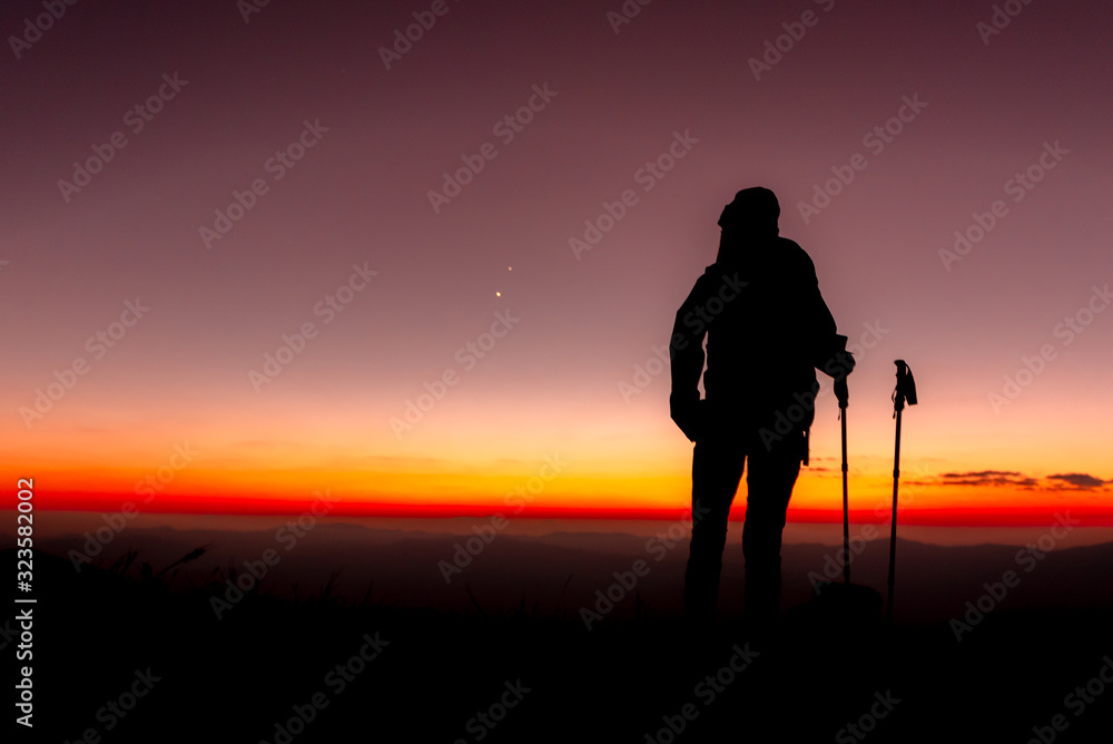 23.10.2019 Friend Group hiking Doi Monjong, Chiang Mai, Thailand., Silhouette Hiking people reaching summit giving at mountain top at sunset. Photo with high shadow and selective focus.