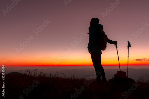 23.10.2019 Friend Group hiking Doi Monjong, Chiang Mai, Thailand., Silhouette Hiking people reaching summit giving at mountain top at sunset. Photo with high shadow and selective focus.