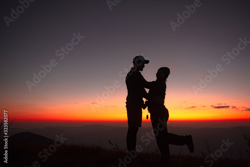 23.10.2019 Friend Group hiking Doi Monjong  Chiang Mai  Thailand.  Sunset Silhouette of Young Lovers Hugging in the Mountains.  Photos with high shadows and selectable focus
