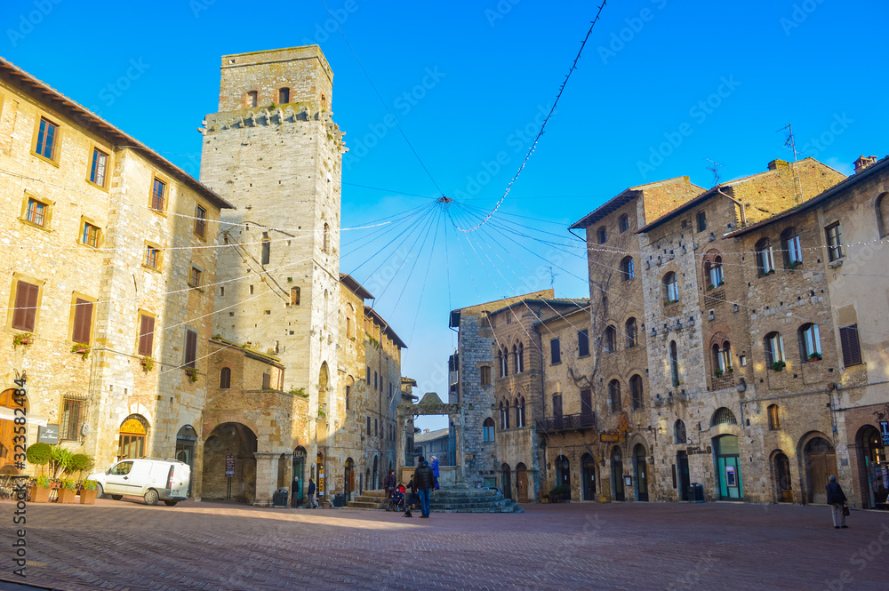 San Gimignano scene at a bright summer morning, with shadows and highlights from sunlight. This city has a lot of towers, so that it is often called 