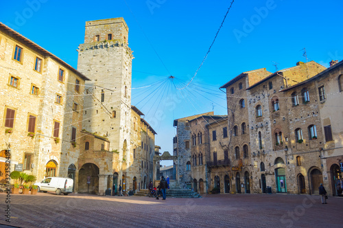 San Gimignano scene at a bright summer morning, with shadows and highlights from sunlight. This city has a lot of towers, so that it is often called "the Manhattan of Middle Ages".