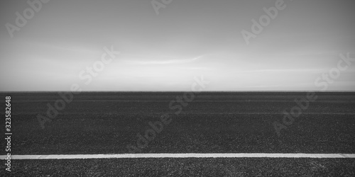 Side view of asphalt road with dark sky background