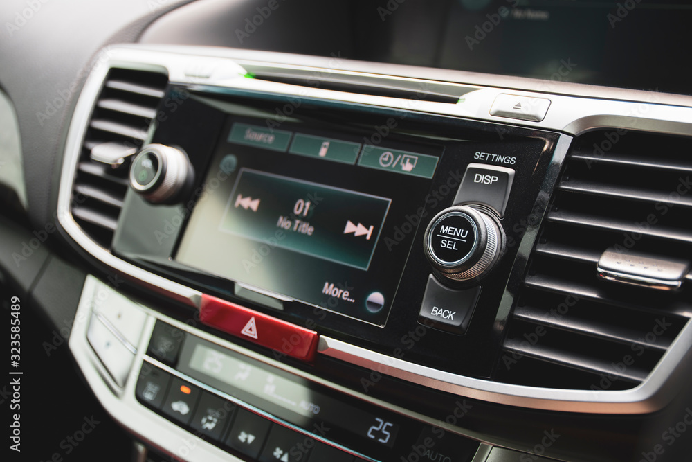 Menu and Select button on multimedia control panel of head unit in luxury car, automotive part concept. Menu and Select button on multimedia control panel of head unit in luxury car, automotive part concept.
