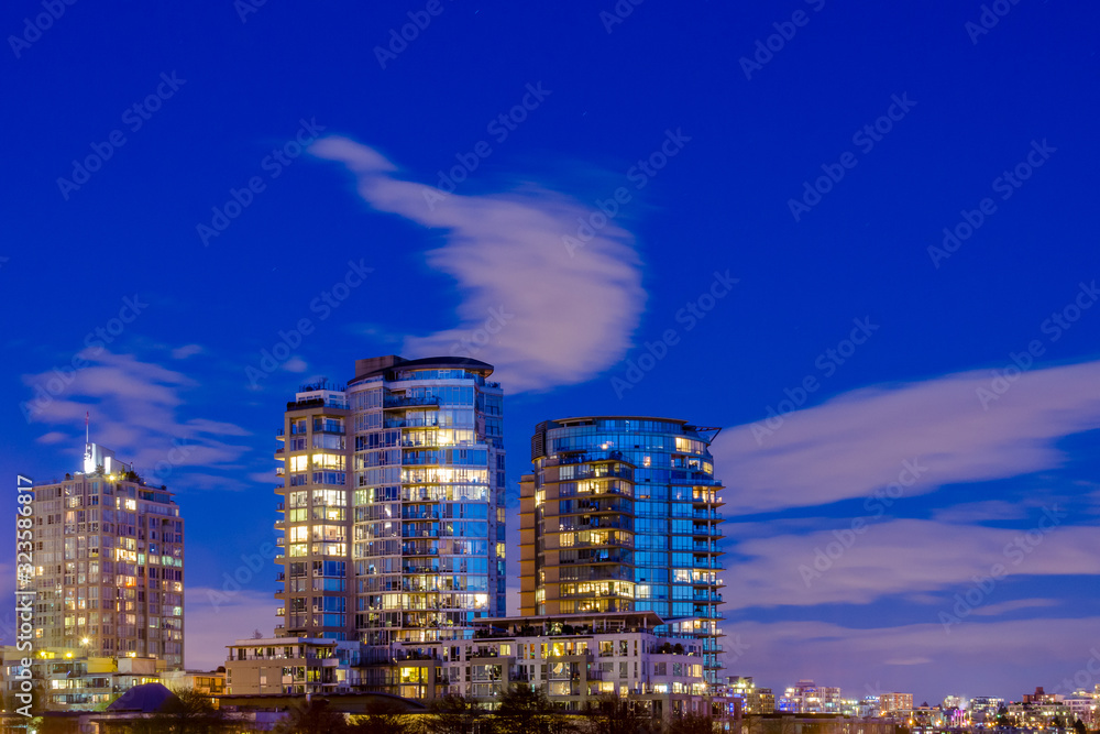 House building and city concept: evening outdoor urban view of modern real estate homes.