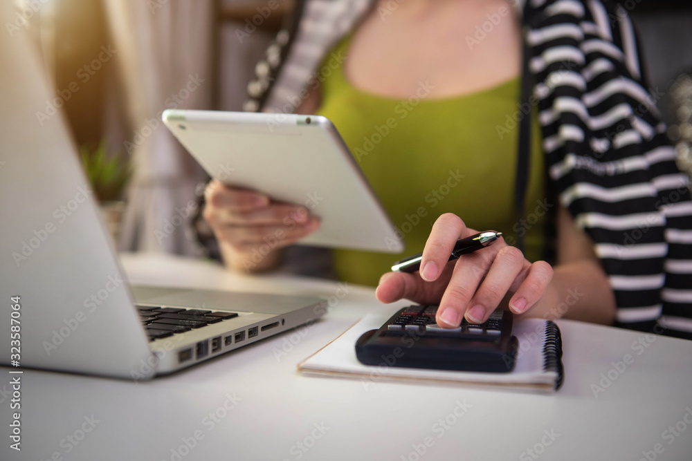 Hand women doing finances and calculate on desk about cost at home office. Hand women doing finances and calculate on desk about cost at home office.