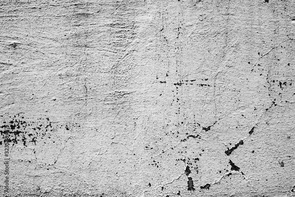Fototapeta premium Texture of a concrete wall with cracks and scratches which can be used as a background