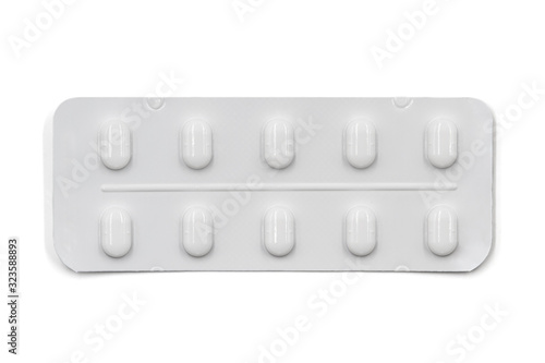 Pills in white blister pack isolated on white background. Global pharmaceutical industry. Closeup, top view