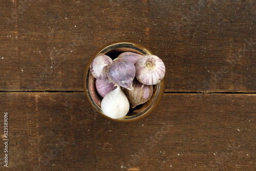 Small solo single clove garlic monobulb garlic single bulb garlic pearl garlic rustic wood background photo