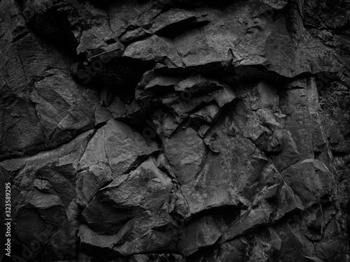 Black white stone background. Mountain close-up. Beautiful rock texture. Detail. Volumetric rocky background. 3D effect.