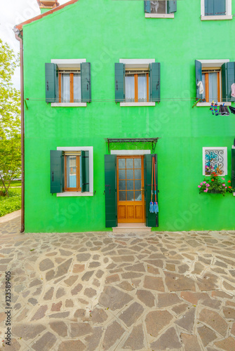 Entrance of a colorful apartment building in Burano  Venice  Italy.