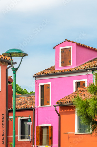 Colorful apartment building with nice waterfront view in Burano  Venice  Italy.