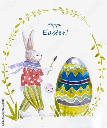 Easter bunny paints an egg. Easter card.