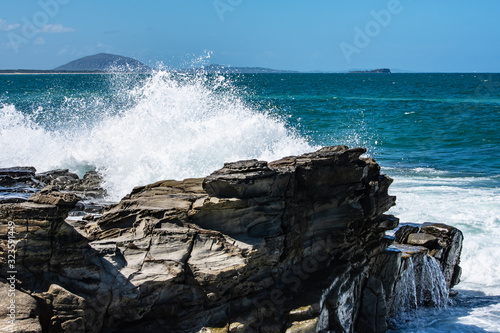 Natures natural beauty, waves crashing on the rocks creating huge sprays of fresh sea water. photo
