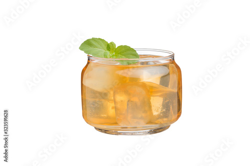 Tea or yellow herbal in a glass with ice And with Peppermint added fragrance Isolated on white background