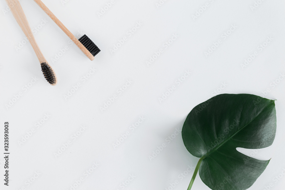 Zero waste concept. Frme of natural eco bamboo toothbrush with monstera leaves on white background Flat Lay Copy space Zero waste concept. Frme of natural eco bamboo toothbrush with monstera leaves on white background Flat Lay Copy space