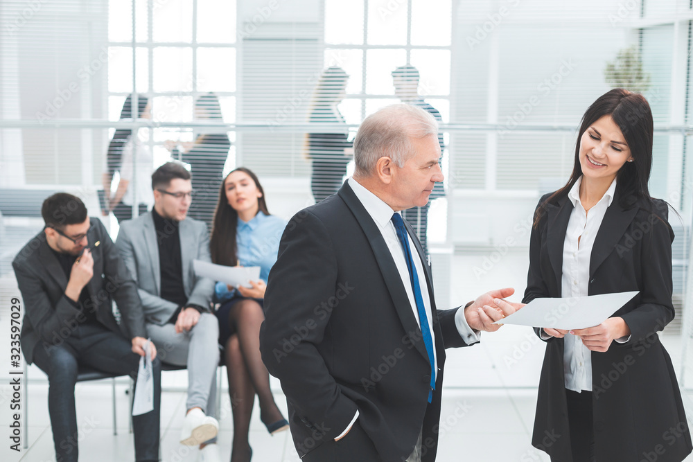 businessman and businesswoman discussing a business document. businessman and businesswoman discussing a business document.