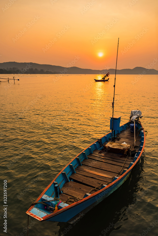 Fishing boats, small boats floating in the sea at sunrise, Concept sea in the morning.