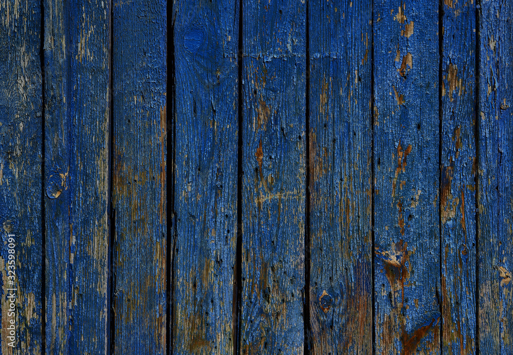 blue wall of old boards with peeling paint