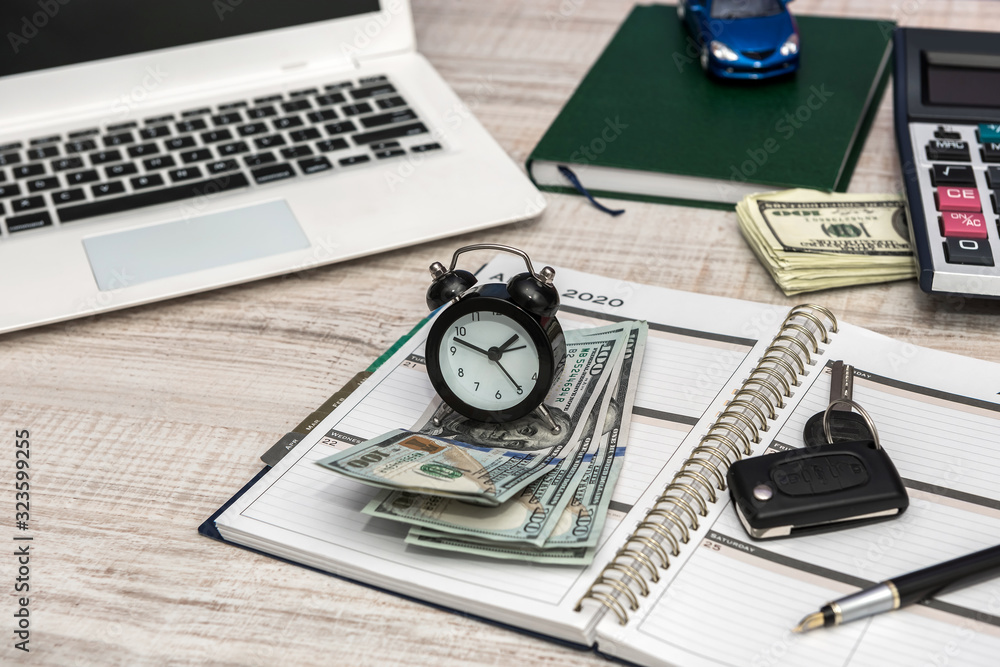 Business - car key, laptop money and notepad on desk Business - car key, laptop money and notepad on desk