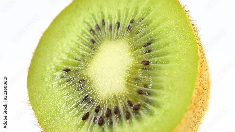 Kiwi rotates, cut tropical fresh fruit, core green entrails. Macro video footage, at an angle view. Kiwi rotates, cut tropical fresh fruit, core green entrails. Macro video footage, at an angle view.