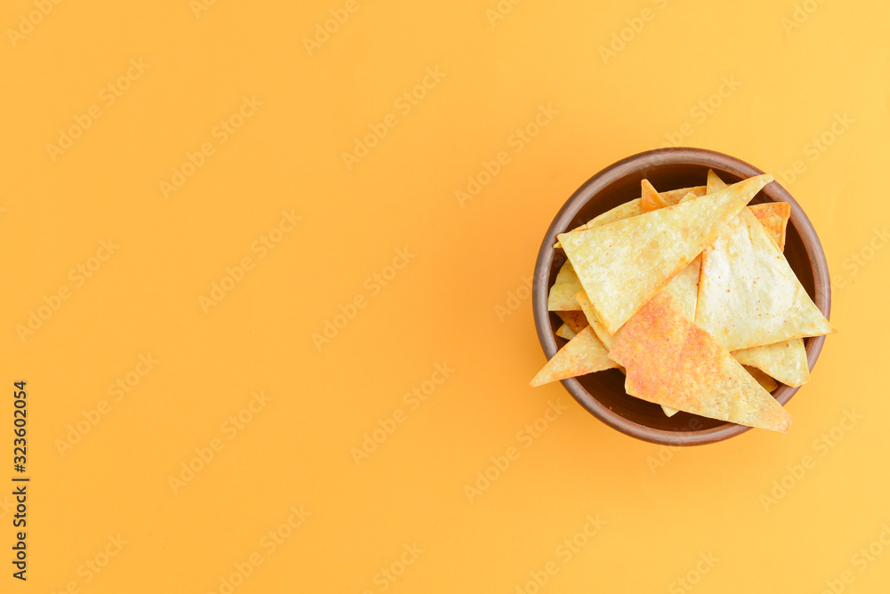 Nacho cheese tortilla chips in a bowl. Crisp golden unhealthy chips