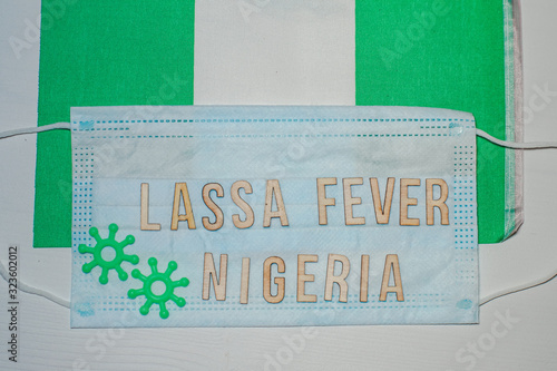 Nigerian flag under words Lassa fever outbreak concept. protective breathing mask and syringe. Lassa hemorrhagic fever LHF endemic in West Africa including Sierra Leone, Liberia, Guinea and Nigeria