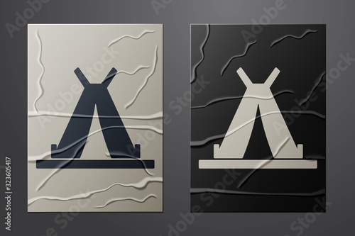 White Traditional indian teepee or wigwam icon isolated on crumpled paper background. Indian tent. Paper art style. Vector Illustration