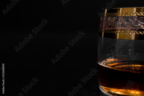 Glass of dark red whiskey, brandy or .bourbon