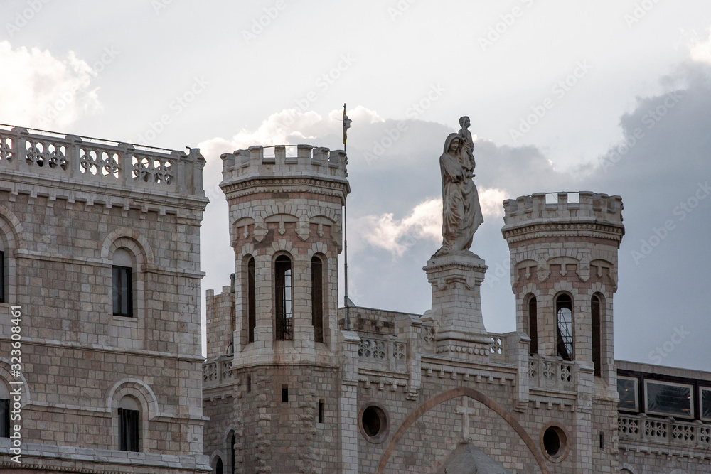 Towers, statue and gothic architecture against the sky