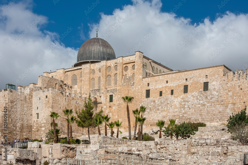The mosque rises above the fortress wall