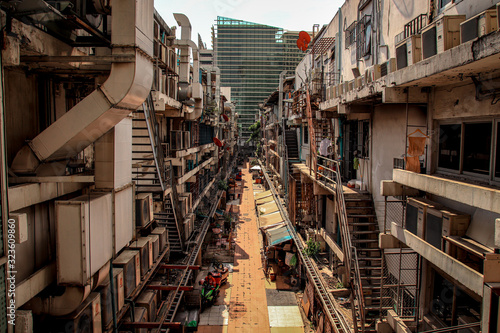 Photography Crowded alley way in the slums of Bangkok City showing poverty and the reality o