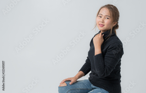 Portrait of young woman in studio, Beautiful young asian woman portrait with Black sweater on white color background, with Copy space for your design.