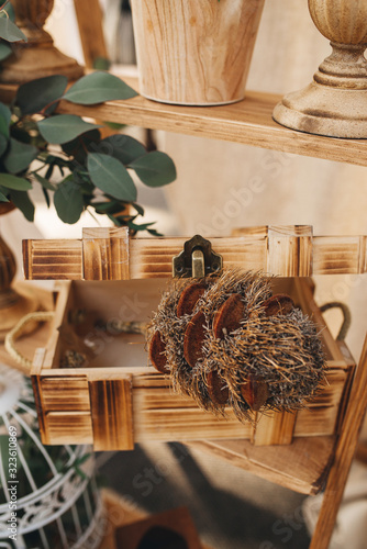 Decor in a rustic stele at a wedding. In a wooden box is a dry unusual flower. Selective focus