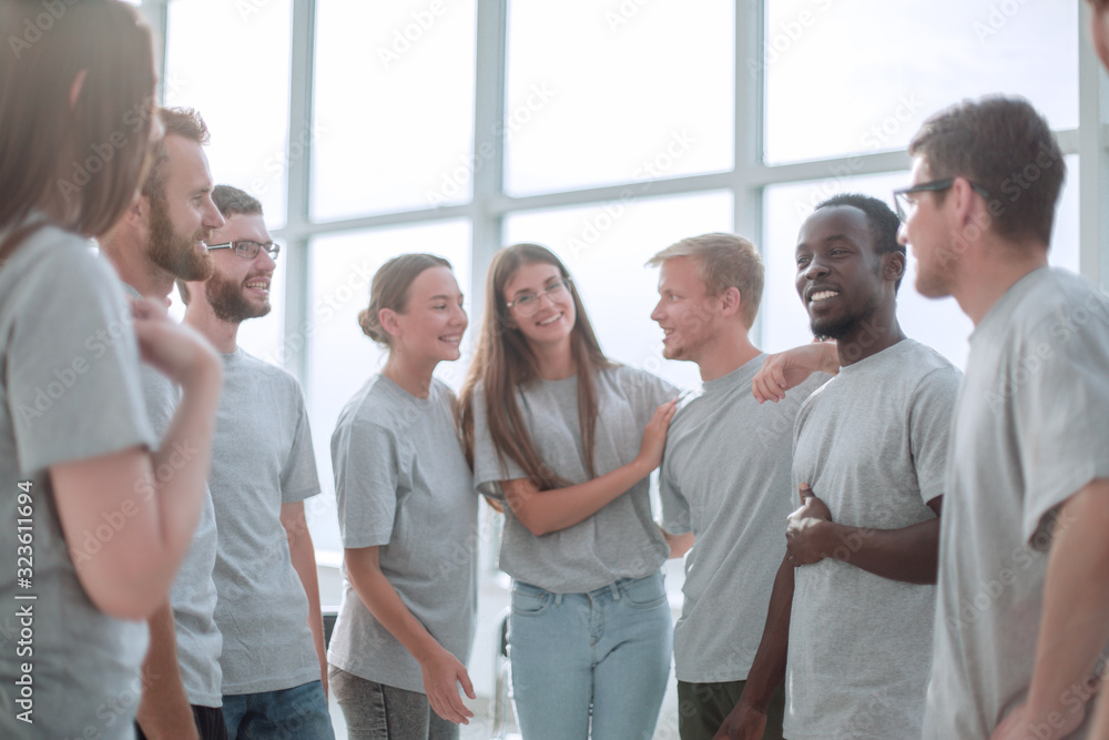 group of diverse young men in grey t-shirts standing together group of diverse young men in grey t-shirts standing together