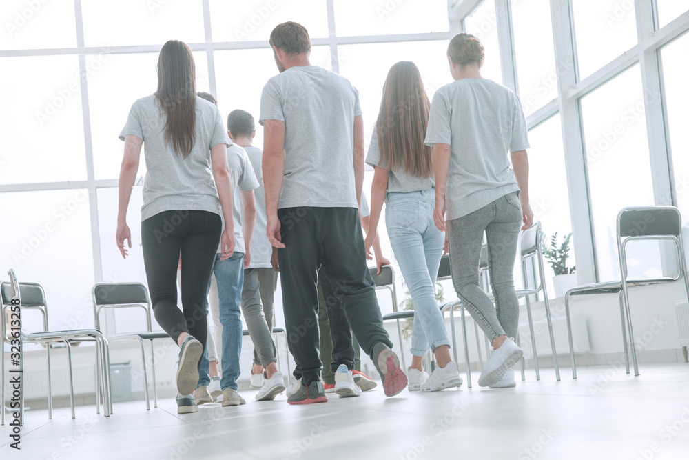 rear view. a group of young people walking into the conference room.