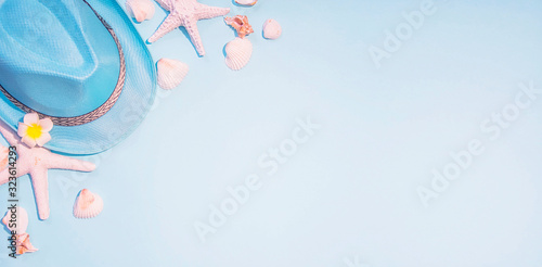 top view of hat and sea shell on light blue paper plank floor for summer vacation time background #323614293