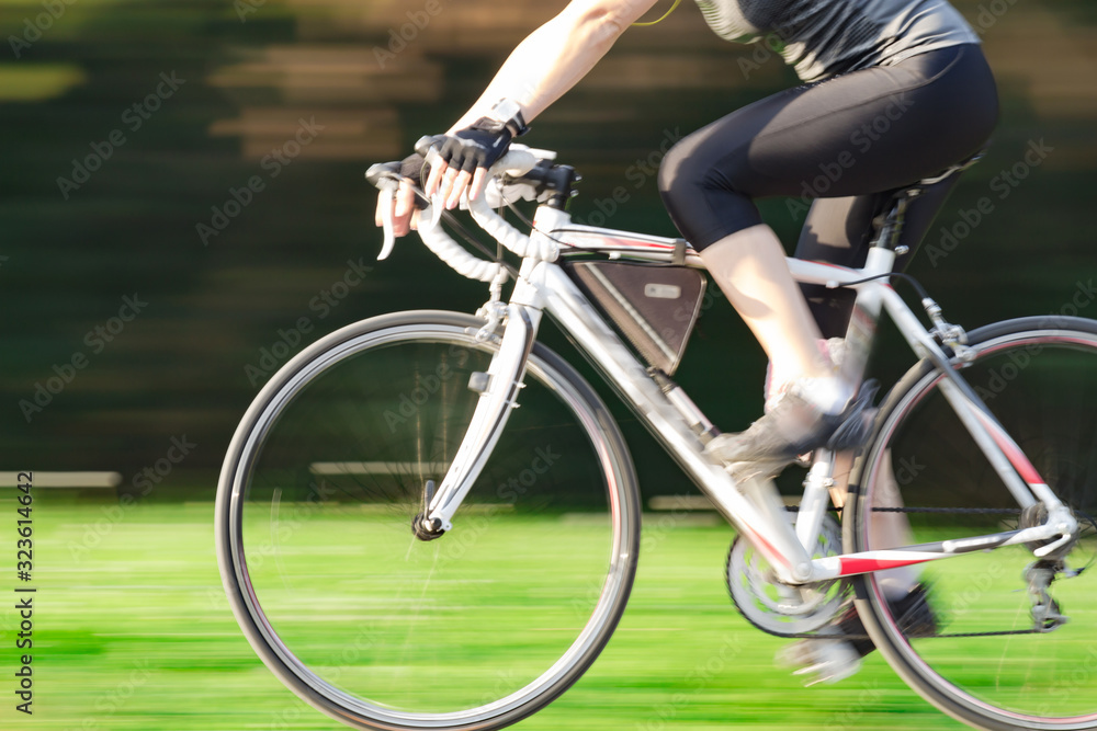 Fototapeta premium Riding bicycle - blurred motion, fast driving.