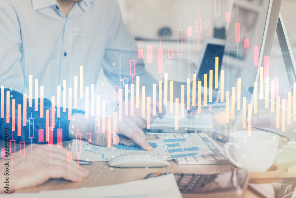 Multi exposure of chart with man typing on computer in office on background. Concept of hard work. Multi exposure of chart with man typing on computer in office on background. Concept of hard work.