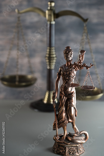 Law and Justice concept. Mallet of the judge, books, scales of justice. Gray stone background, reflections on the floor, place for typography. Courtroom theme.. Wooden rustic background
