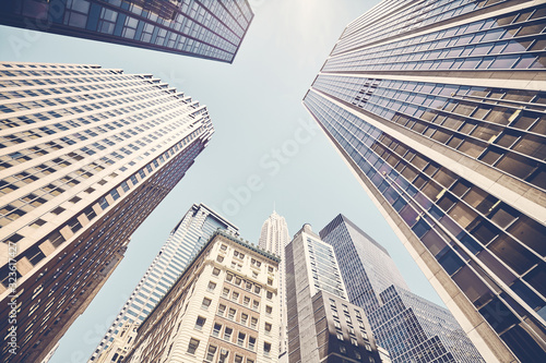 Manhattan skyscrapers against the sun  color toning applied  New York City  USA.