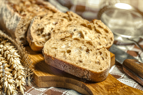 loaf of bread on wooden background, food closeup.Fresh homemade bread.French bread. Bread at leaven.Ciabatta.