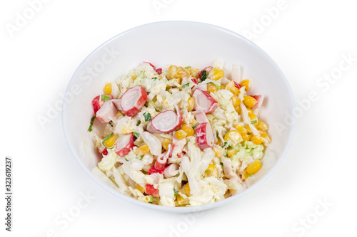 Salad of crab sticks with vegetables in bowl