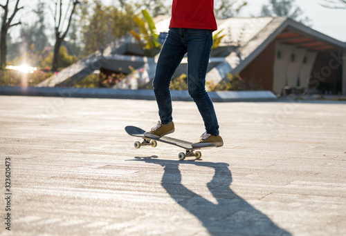 Skateboarder skateboarding at sunrise park