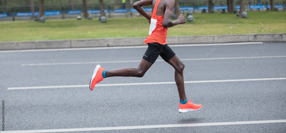 Fototapeta premium Marathon runner running on the race on city road