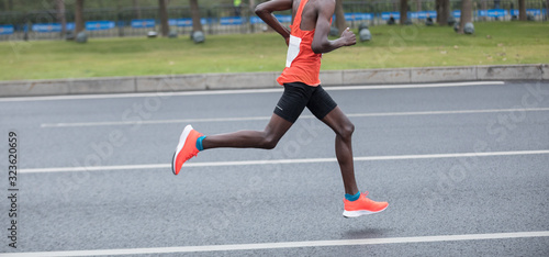 Marathon runner running on the race on city road