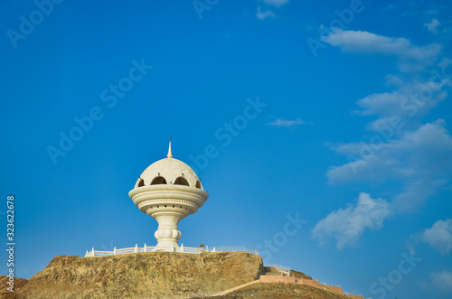 Frankincense Burner Monument on the hill and the blue sky in the background. From Muscat, Oman.