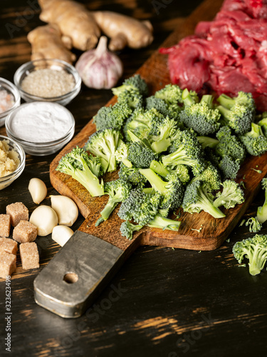Selected vegetables broccoli and raw meat on cutting desk for cooking healthy food recipe meal.