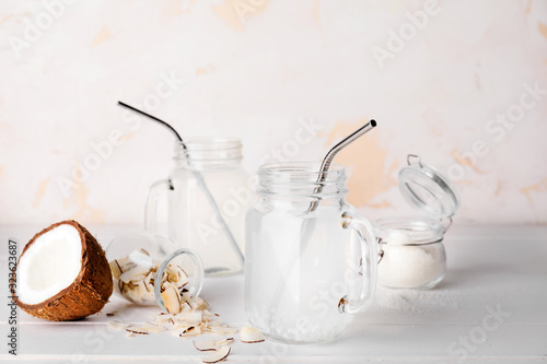 Mason jars of fresh coconut water on table