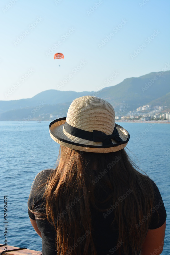  Girl in a hat with a sea view. A photo